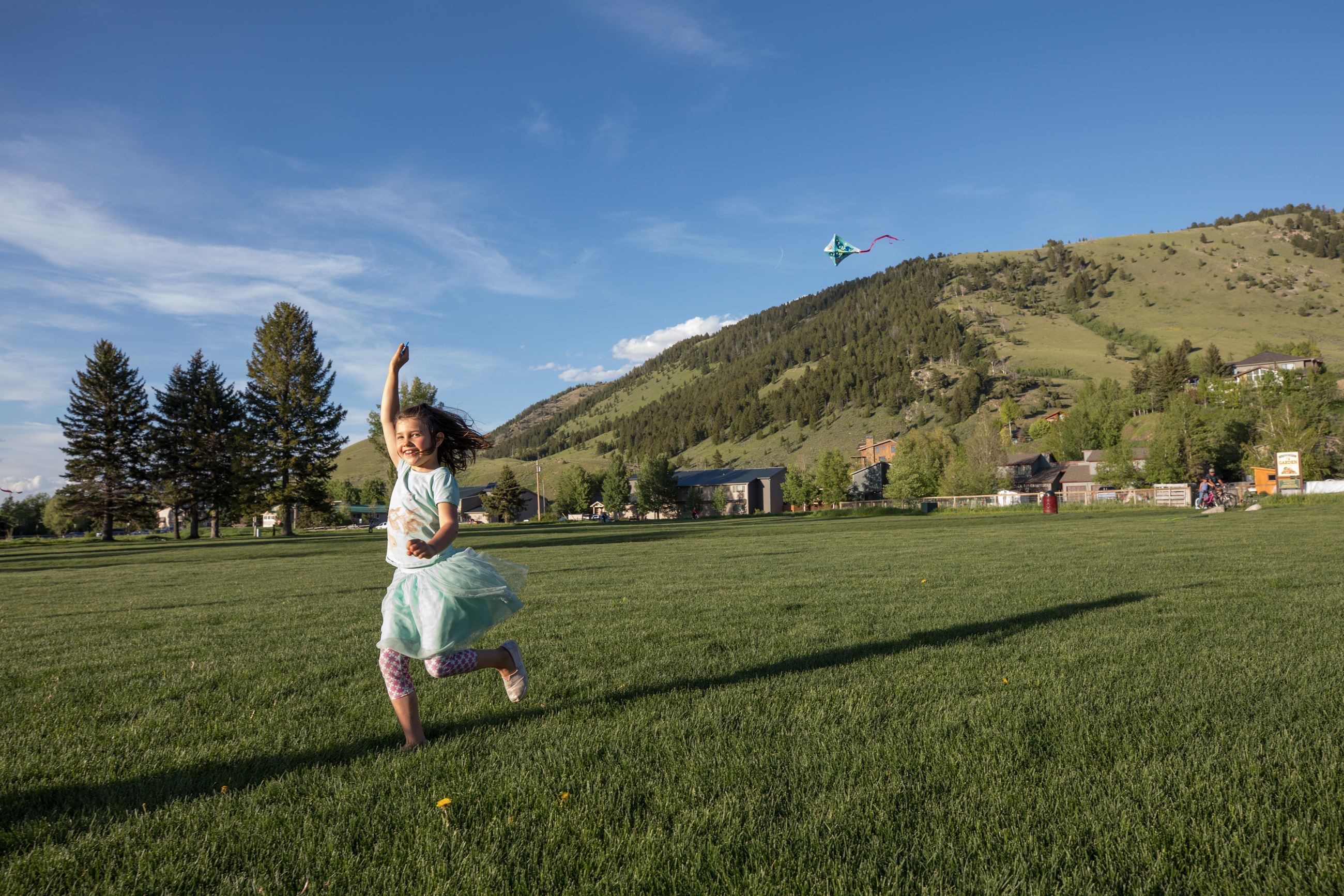 May Park Child Running with kite in summer